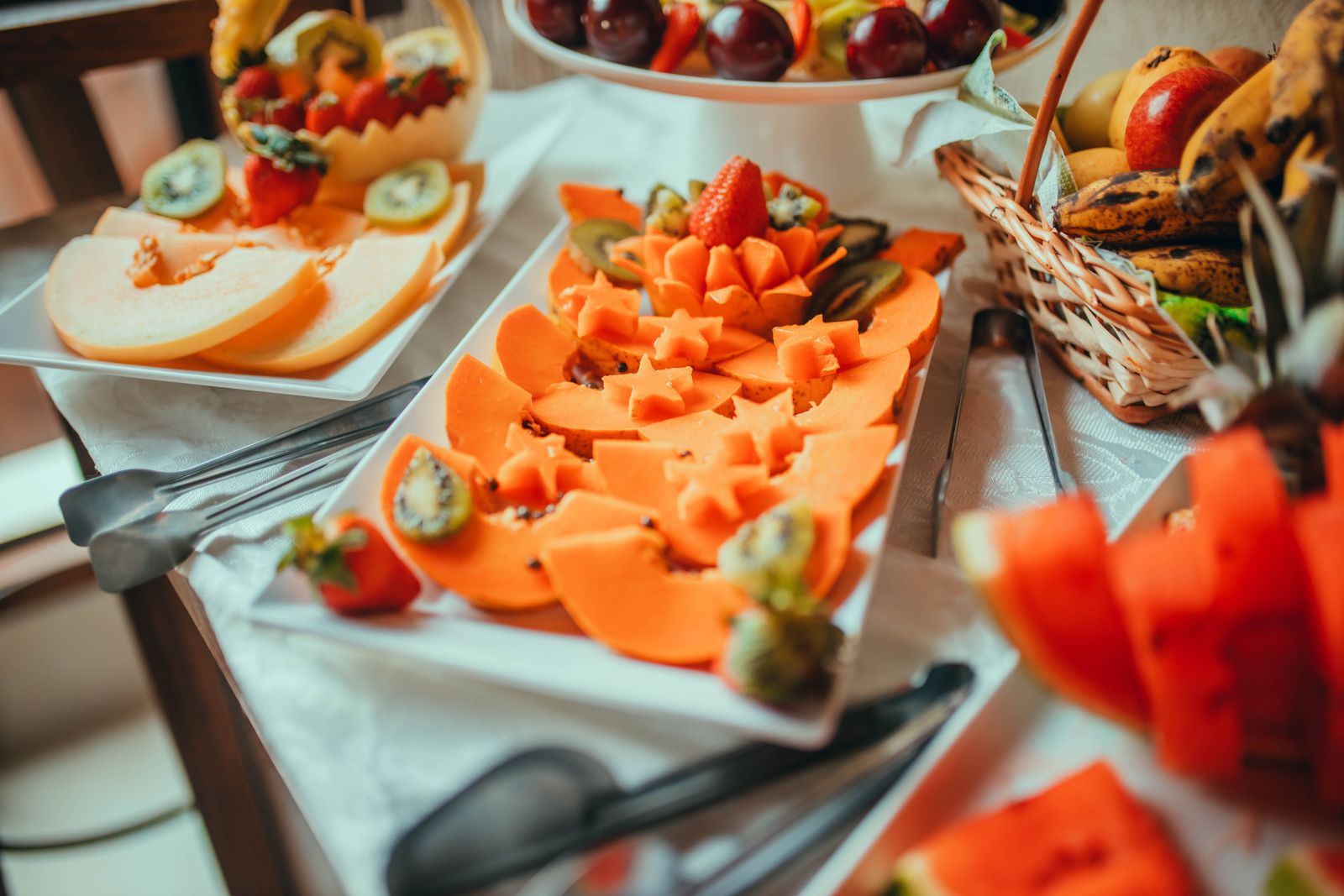 Platter of sliced melon, kiwi, strawberries and grapes